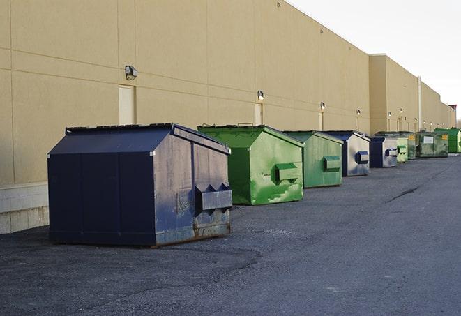 a collection of bright and vibrant dumpsters in a construction zone in Bapchule AZ